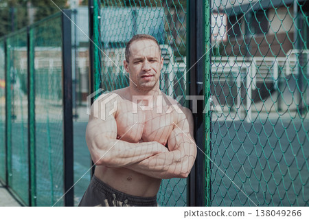 A CrossFit man poses for the camera on a sports A CrossFit man poses for the camera on a sports 138049266