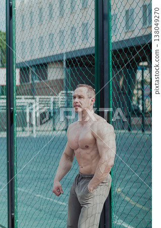 A CrossFit man poses for the camera on a sports A CrossFit man poses for the camera on a sports 138049270