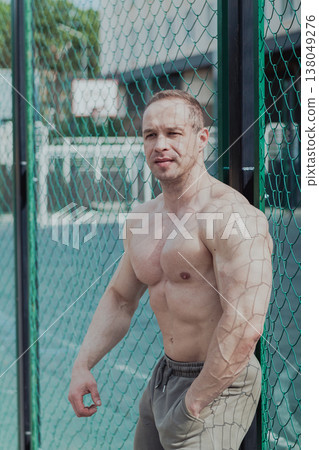 A CrossFit man poses for the camera on a sports A CrossFit man poses for the camera on a sports 138049276