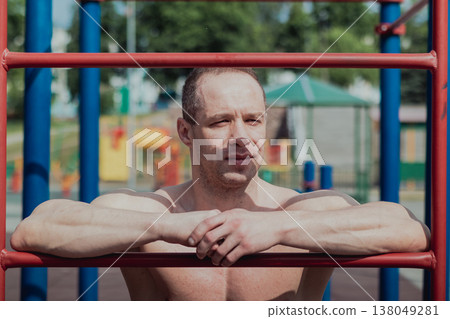 A CrossFit man poses for the camera on a sports A CrossFit man poses for the camera on a sports 138049281