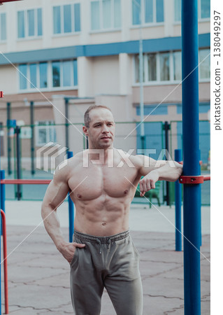 A CrossFit man poses for the camera on a sports A CrossFit man poses for the camera on a sports 138049297
