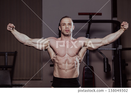 Bodybuilder posing in the gym, aesthetic body 138049302