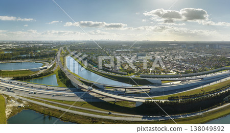View from above of USA transportation infrastructure. Aerial view of american freeway intersection with fast driving cars and trucks in Miami, Florida View from above of USA transportation infrastructure. Aerial view of american freeway intersection with fast driving cars and trucks in Miami, Florida 138049892