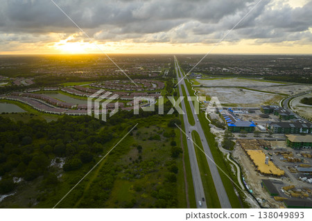 View from above of unfinished frame of apartment condos with wooden roof beams under construction. Development of residential housing in US suburbs. Real estate market in the USA 138049893