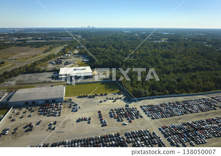 Used damaged cars on auction reseller company big parking lot ready for resale services. Sales of secondhand vehicles for rebuilt or salvage title 138050007