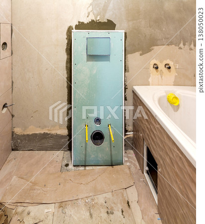 Unfinished reconstruction of bathroom or toilet with ceramic tiles installed on walls of drywall, place for lavatory and bath. Unfinished reconstruction of bathroom or toilet with ceramic tiles installed on walls of drywall, place for lavatory and bath. 138050023