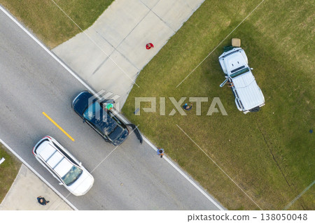 Traffic accident on American street in Florida. First responders helping victims of car crash on road in USA. Aerial view of emergency services responding to accident site Traffic accident on American street in Florida. First responders helping victims of car crash on road in USA. Aerial view of emergency services responding to accident site 138050048