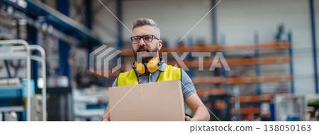 Warehouse or factory worker carrying products in box. 138050163