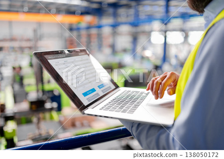Close up of factory manager with laptop in industrial factory. 138050172