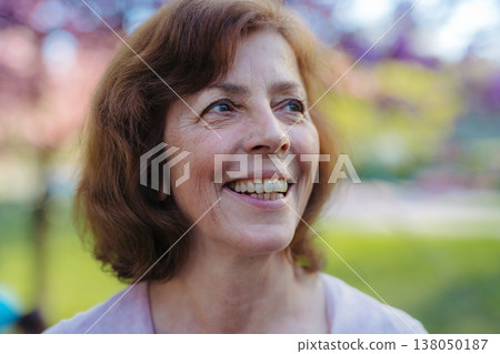 Beautiful senior woman standing outside in spring nature. Copy space. Beautiful senior woman standing outside in spring nature. Copy space. 138050187