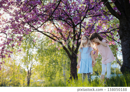 Sisters back to back in spring nature. Sisters back to back in spring nature. 138050188