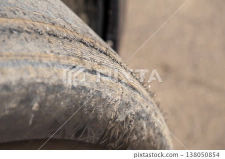 A close up shows the surface of a wheel while a court is visible in the background under bright daylight conditions A close up shows the surface of a wheel while a court is visible in the background under bright daylight conditions 138050854