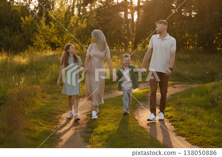 Gentle Twilight Ambiance With Kin Wandering Down Rural Track Casting Extended Silhouettes Gentle Twilight Ambiance With Kin Wandering Down Rural Track Casting Extended Silhouettes 138050886