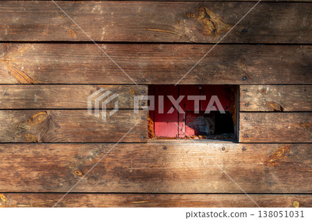 Wooden beehive wall with entrance opening for bees, rustic texture with red interior, concept of beekeeping, pollination, sustainability and natural ecosystem Wooden beehive wall with entrance opening for bees, rustic texture with red interior, concept of beekeeping, pollination, sustainability and natural ecosystem 138051031