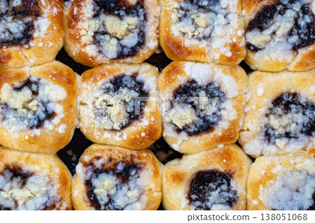 Top view of traditional czech buns filled with plum jam and topped with curd and crumble on baking tray, homemade recipe, rustic dessert, authentic sweet pastry concept Top view of traditional czech buns filled with plum jam and topped with curd and crumble on baking tray, homemade recipe, rustic dessert, authentic sweet pastry concept 138051068