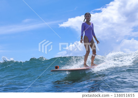 Vibrant Scene Of Young Woman Riding On Longboard In Sunny Seaside Environment Vibrant Scene Of Young Woman Riding On Longboard In Sunny Seaside Environment 138051655