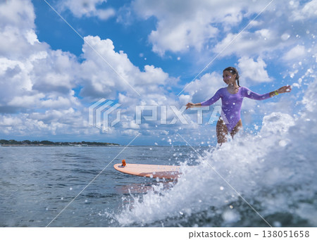 Relaxed Young Woman Enjoying Calm Ride Over Gentle Ocean Wave Beneath Sunny Sky Relaxed Young Woman Enjoying Calm Ride Over Gentle Ocean Wave Beneath Sunny Sky 138051658
