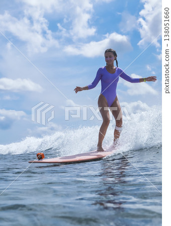 Cheerful Female Surfer Maintains Bold Posture Amidst Vibrant Spray And Sky Cheerful Female Surfer Maintains Bold Posture Amidst Vibrant Spray And Sky 138051660