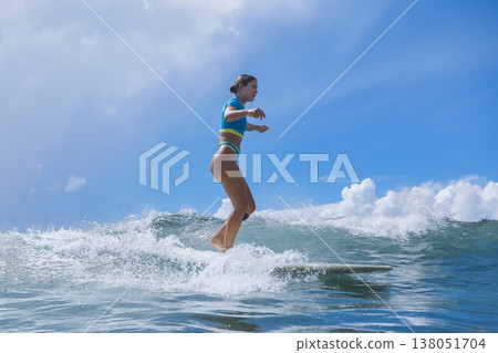 Peaceful Surf Dawn, Calm Dawn Sees Woman Rider Enjoying Morning Surf Session Peaceful Surf Dawn, Calm Dawn Sees Woman Rider Enjoying Morning Surf Session 138051704
