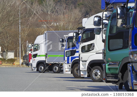 A line of large trucks in the parking area A line of large trucks in the parking area 138053368