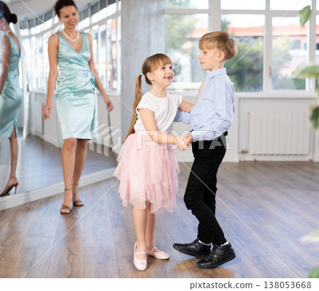 Boy and girl in pair train to dance contemporary vigorous waltz during classes. 138053668