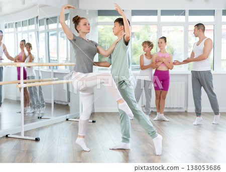 Teenage girl and boy practicing ballet positions in pair in dance studio Teenage girl and boy practicing ballet positions in pair in dance studio 138053686