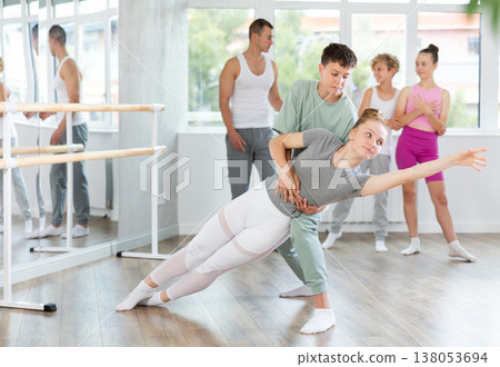 Boy and girl in pair train to perform ballet dance during rehearsal in studio Boy and girl in pair train to perform ballet dance during rehearsal in studio 138053694