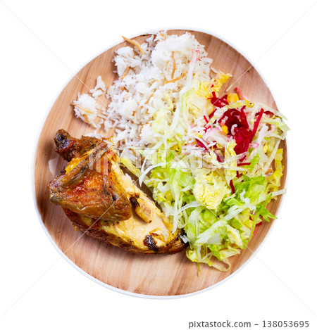 Tender meat of roasted chicken is garnished with boiled rice, vegetable salad. Tender meat of roasted chicken is garnished with boiled rice, vegetable salad. 138053695