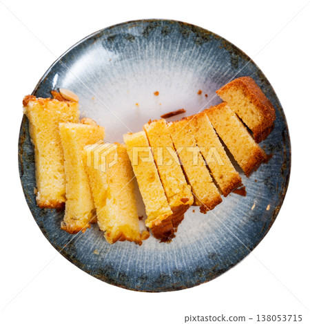 Restaurant serves classic dessert - ceramic plate accommodates small piece of orange sponge cake 138053715