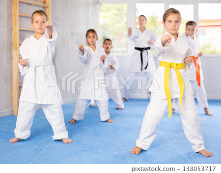 Young karate students gather in dojo Young karate students gather in dojo 138053717
