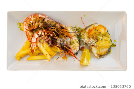 Pieces of fried hake are served with side dish and seafood 138053760