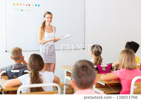 Schoolchildren listening to teacher Schoolchildren listening to teacher 138053766