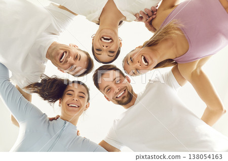 Bottom view portrait of a joyful smiling people friends students looking down into camera. 138054163