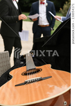 Acoustic guitar in case prepared for outdoor wedding ceremony music Acoustic guitar in case prepared for outdoor wedding ceremony music 138054171
