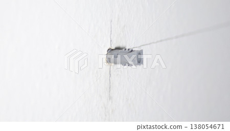 Tool is used to drill a hole in the wall for installation of a fixture at a construction site 138054671