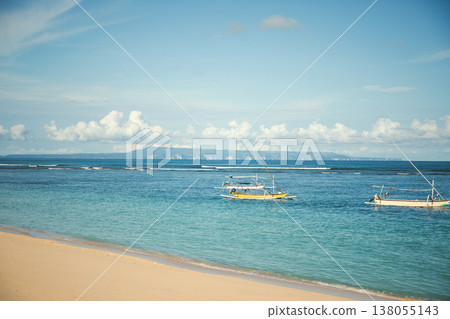 Boats are fishing in clear waters near Bali shore 138055143