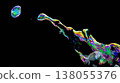 Close-up of rainbow-colored soap bubbles floating against a black background. 138055376