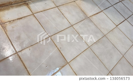 Realistic dirty old beige floor tiles texture with stained black grout lines 138056573