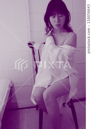 Woman sitting on chair Woman sitting on chair 138056643