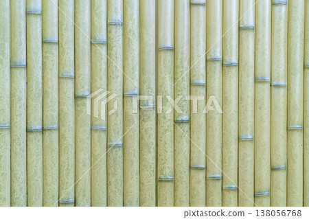 Vertical light green and yellow bamboo sticks texture background. Natural pattern of bamboo poles used for wall decoration or fence. Eco-friendly natural material for modern design and architecture. 138056768