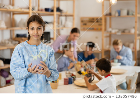 Preteen girl standing in art studio Preteen girl standing in art studio 138057486