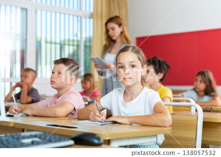Schoolgirl sitting in classroom during lesson in elementary school Schoolgirl sitting in classroom during lesson in elementary school 138057532