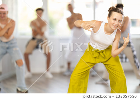 Teenage girl dancing hip hop in group 138057556