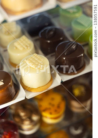 Closeup of various delicious sweet cakes and pastries displayed in bakery display case Closeup of various delicious sweet cakes and pastries displayed in bakery display case 138057591