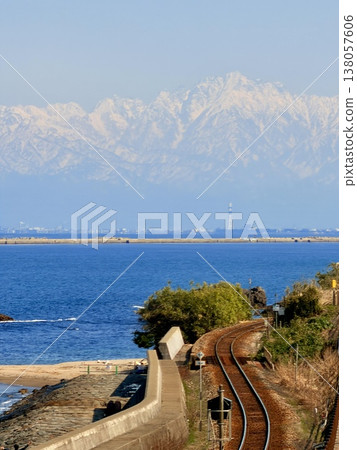Onna-iwa Rock and the snow-covered Tateyama mountain range as seen from Amaharashi Coast in Takaoka City, Toyama Prefecture. Onna-iwa Rock and the snow-covered Tateyama mountain range as seen from Amaharashi Coast in Takaoka City, Toyama Prefecture. 138057606