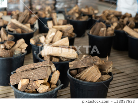 Firewood stacked in plastic buckets in store warehouse Firewood stacked in plastic buckets in store warehouse 138057658
