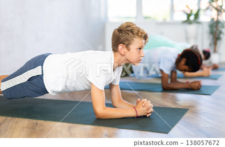 Young boy doing pilates in group of children Young boy doing pilates in group of children 138057672