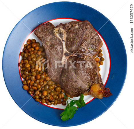 Baked piece of veal fillet garnished with boiled beans. 138057679