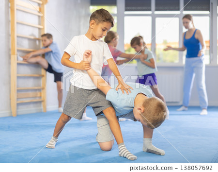 Girls and boys of performing protection with wring hands during training in self-defense 138057692