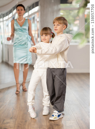 Boy with pair girl in sport wear train to dance contemporary vigorous hustle during classes. Boy with pair girl in sport wear train to dance contemporary vigorous hustle during classes. 138057708